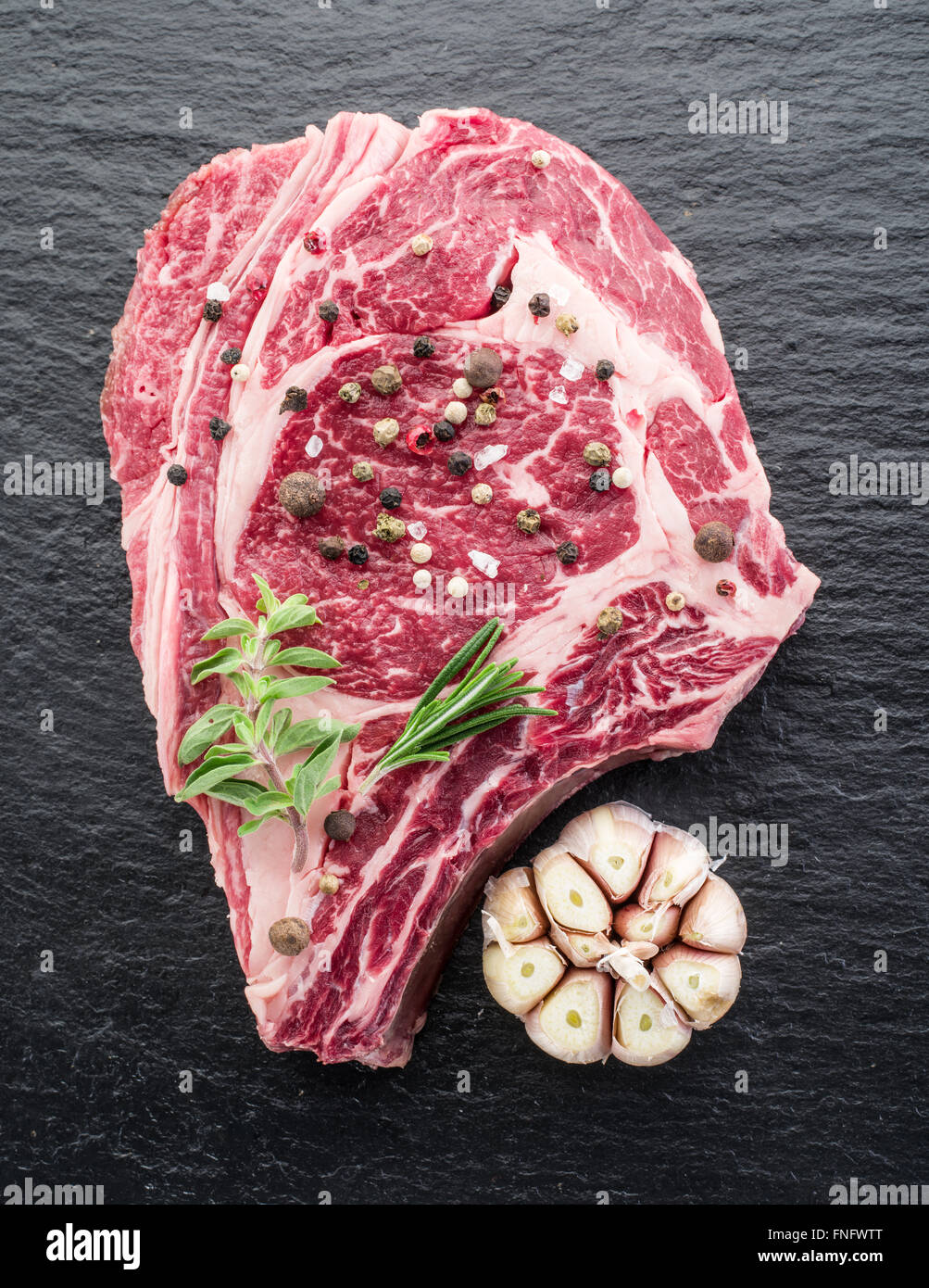 Rib eye steak with spices on the black background Stock Photo Alamy