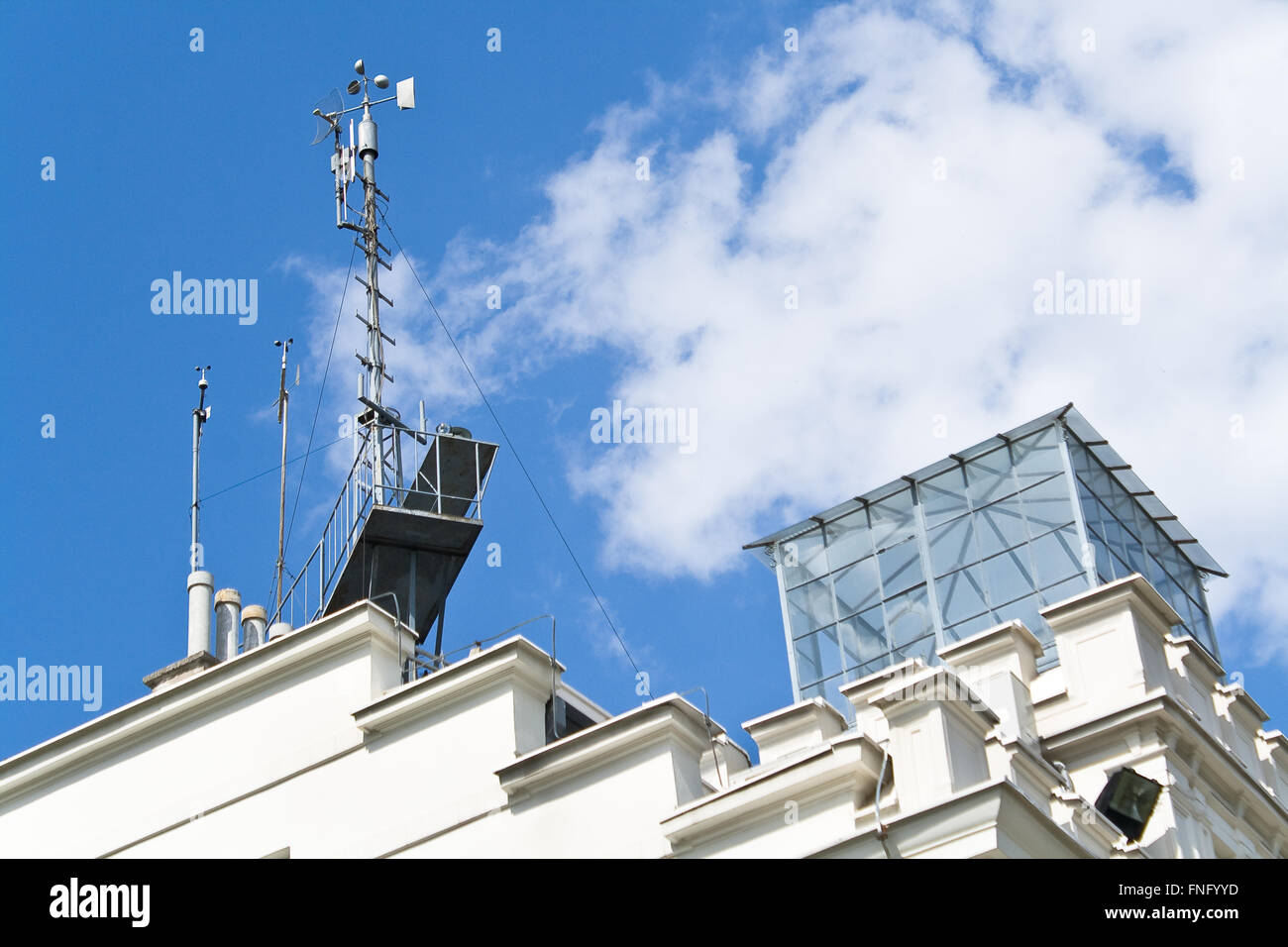 Meteorological devices on roof over blue sky Stock Photo