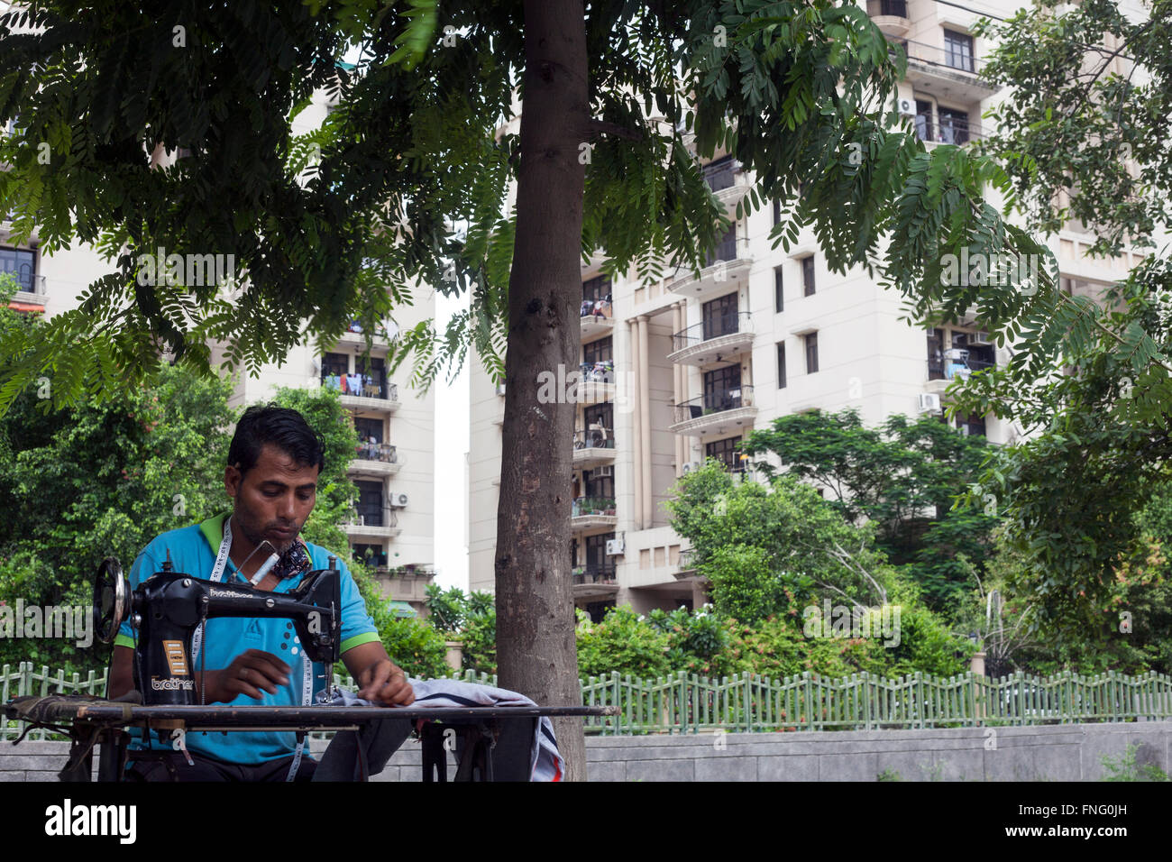 Man, sewing machine, suburbs, manual work Stock Photo Alamy