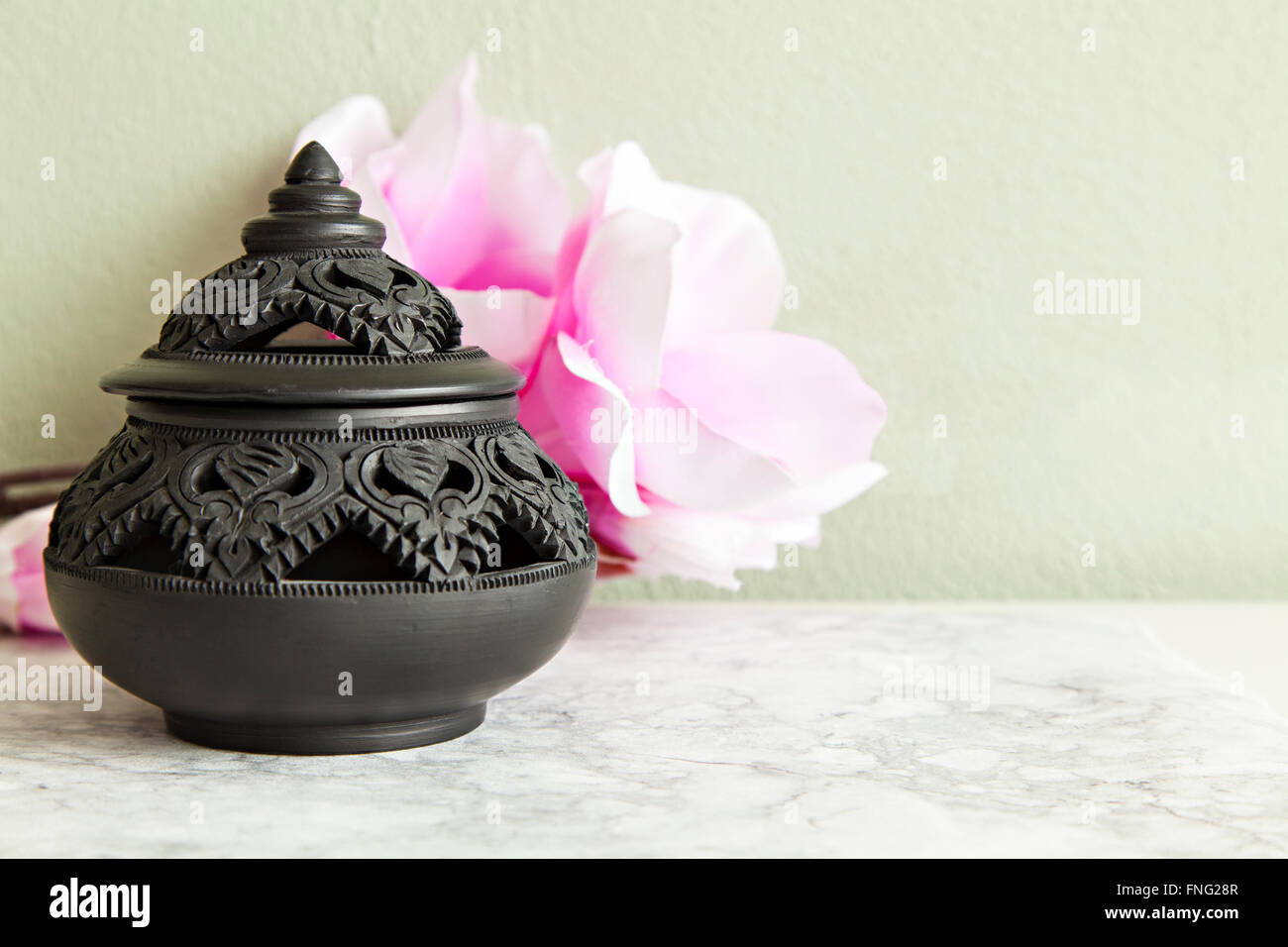 Image of a traditional clay pot from Thailand, with decorative carvings. Stock Photo