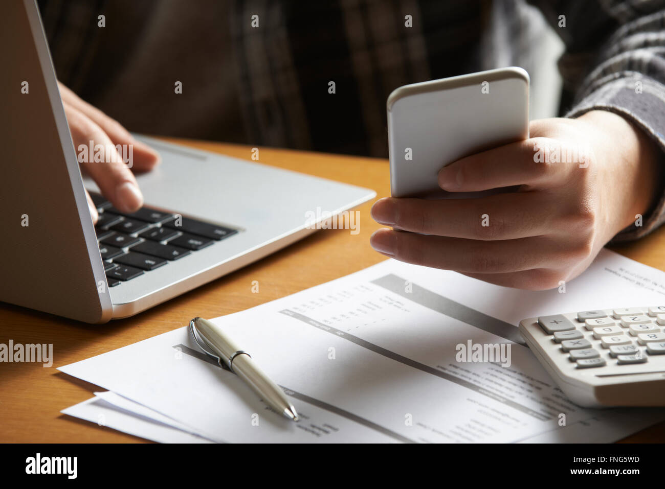 Man Doing On Line Banking And Finance At Home Stock Photo