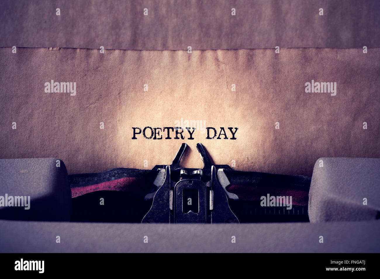 closeup of an old typewriter and the text poetry day written with it in a yellowish foil Stock Photo