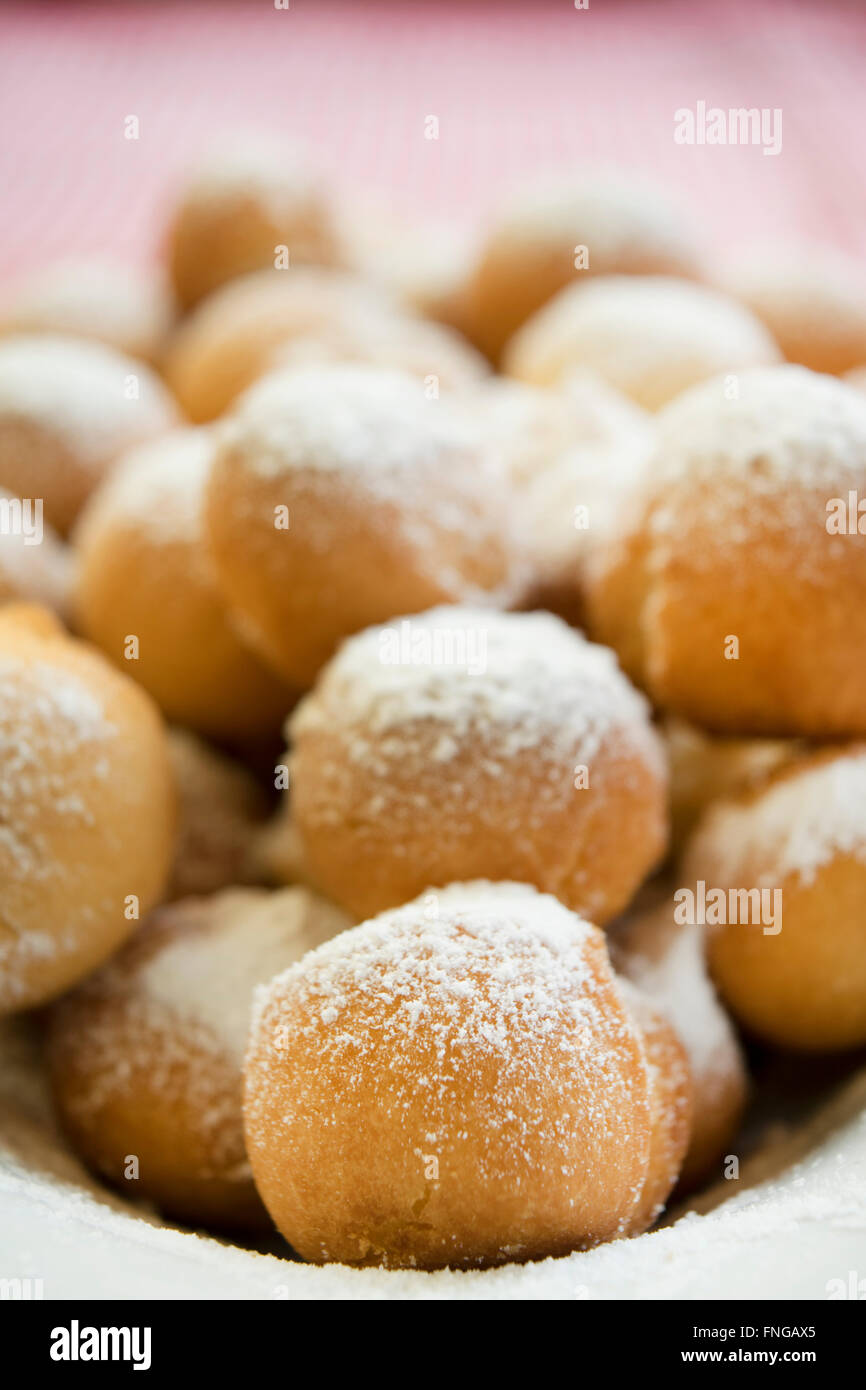 castagnole are fried  sweet dough balls with icing sugar famaus In Italy as the dessert of Carnival. Stock Photo
