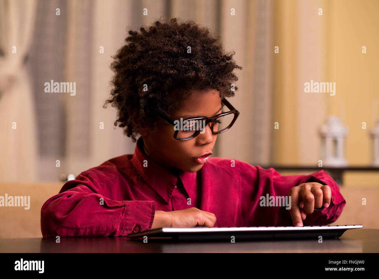 Afro boy using wireless keyboard. Stock Photo
