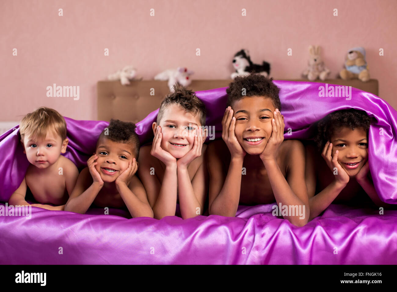 Five kids on sleeping bed Stock Photo Alamy