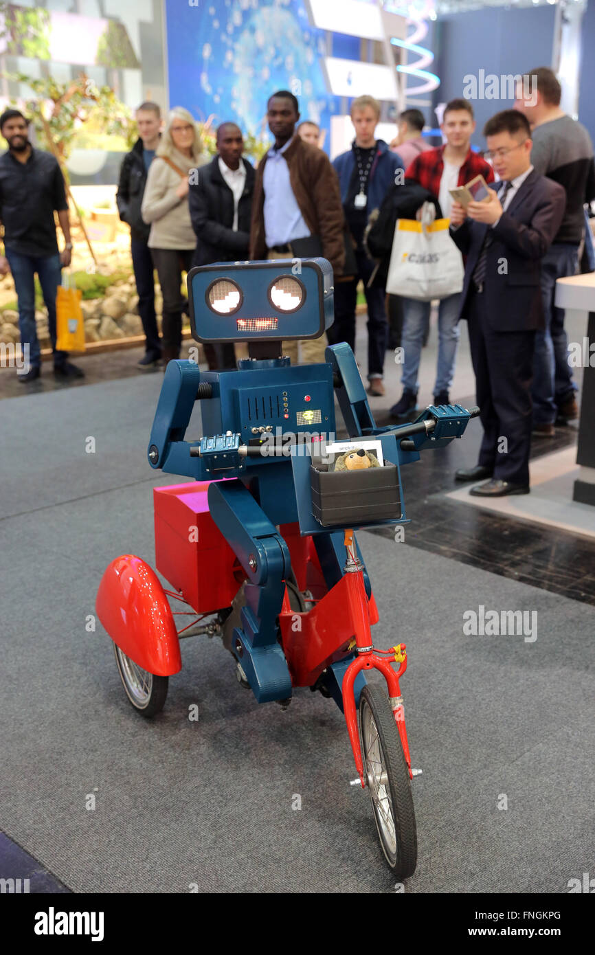 Germany, Hannover, 14.March 2016. CeBIT digital technology trade fair, human robot on tricycle. Stock Photo