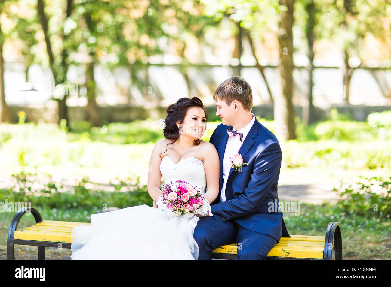 wedding Bride and groom on a bench with nature landscape scenery