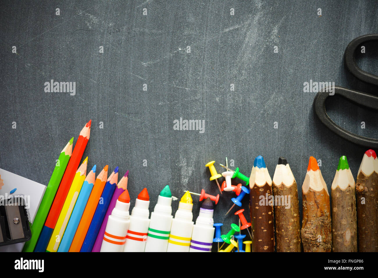 Blackboard background with school supplies suggesting back to school season Stock Photo