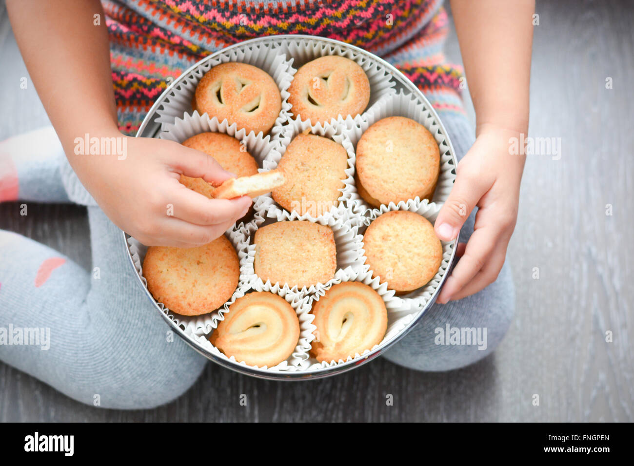 Child holding a box of Danish butter cookies Stock Photo Alamy