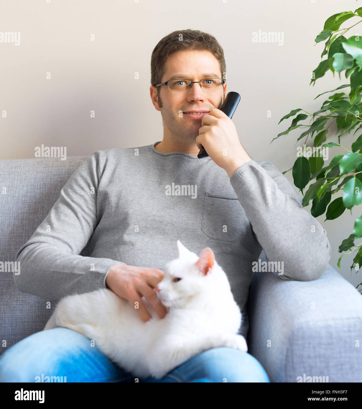 Man relaxing on the sofa with tv remote control. Watching TV with his