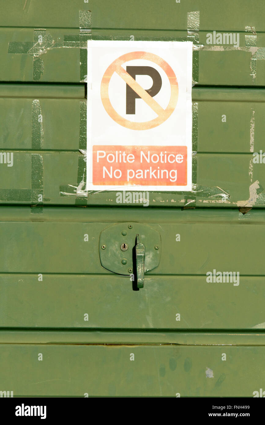 No parking sign taped to garage door Stock Photo Alamy