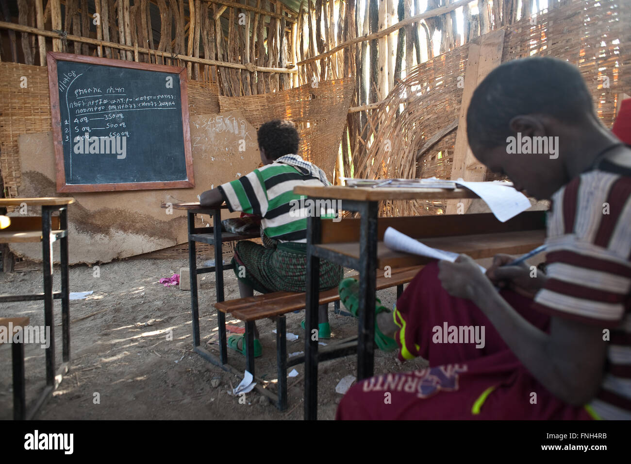 Boys are learning mathematics in the classroom of a village school. Both belong to the Afar tribe ( Ethiopia) Stock Photo