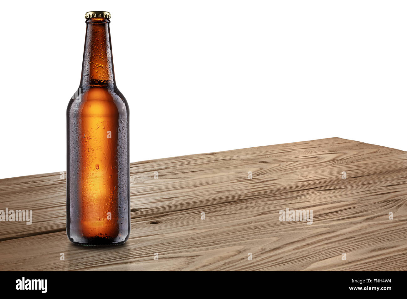 Ful, sealed brown bottle of beer standing on rustic wooden table. Mockup. Clipping paths for both bottle and background. Infinit Stock Photo