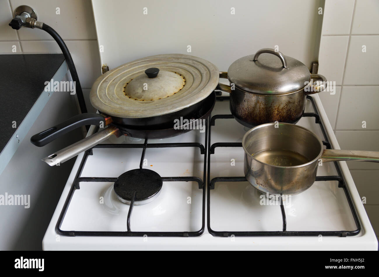 pans and pots on a gas cooker Stock Photo