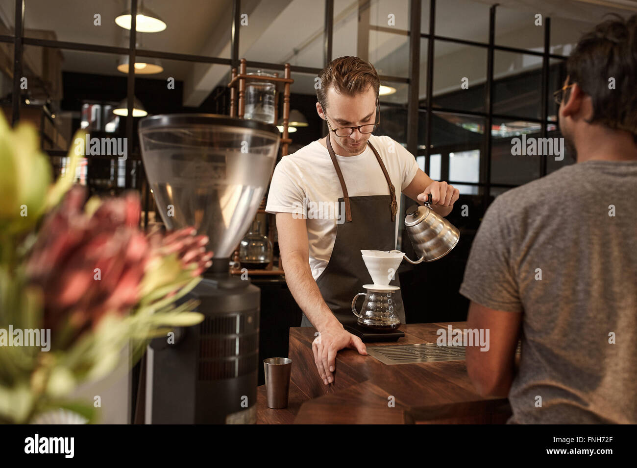 Barista pouring coffee through filter in modern cafe Stock Photo Alamy
