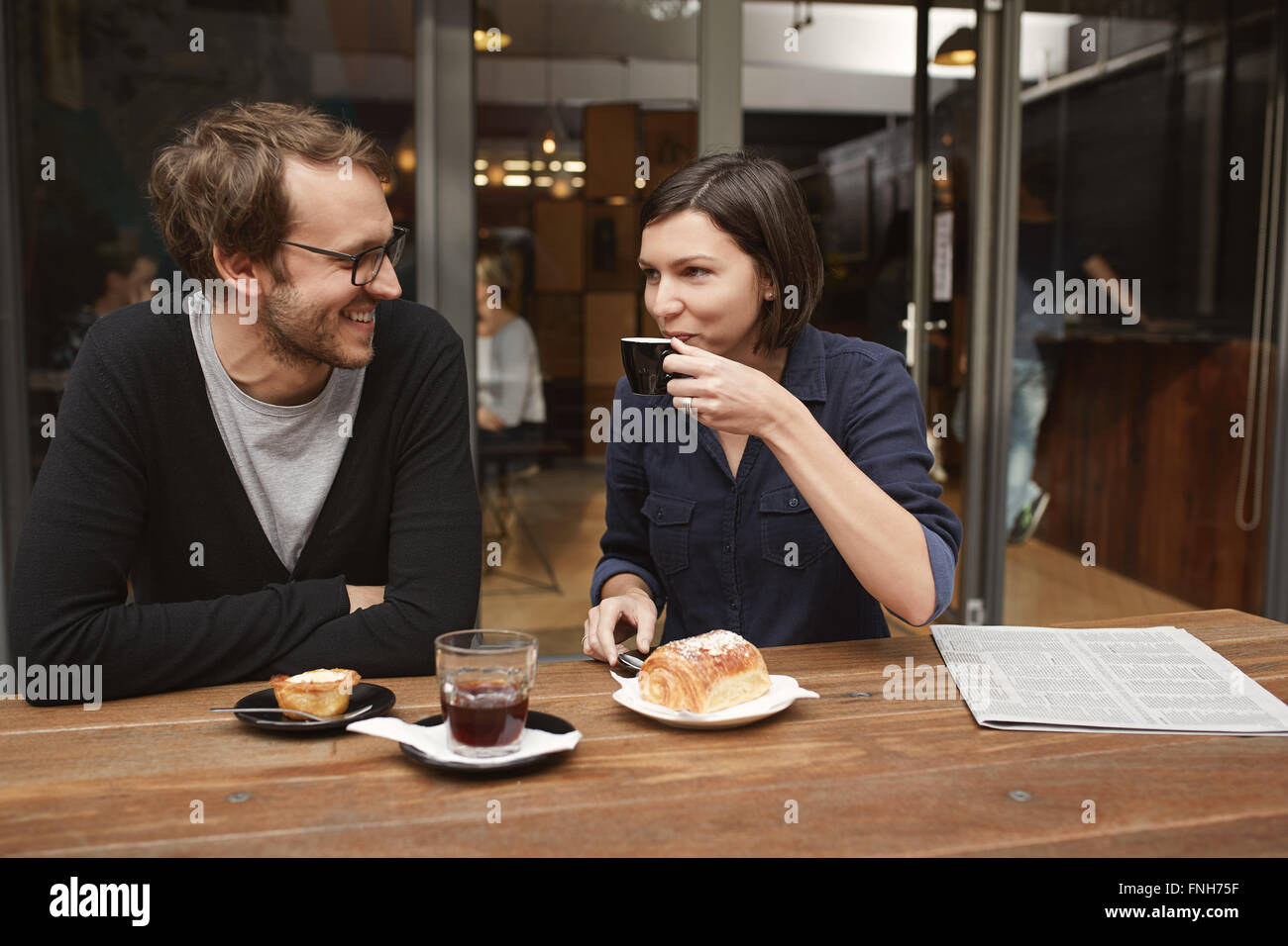 Candid shot of a young couple at outdoor cafe Stock Photo