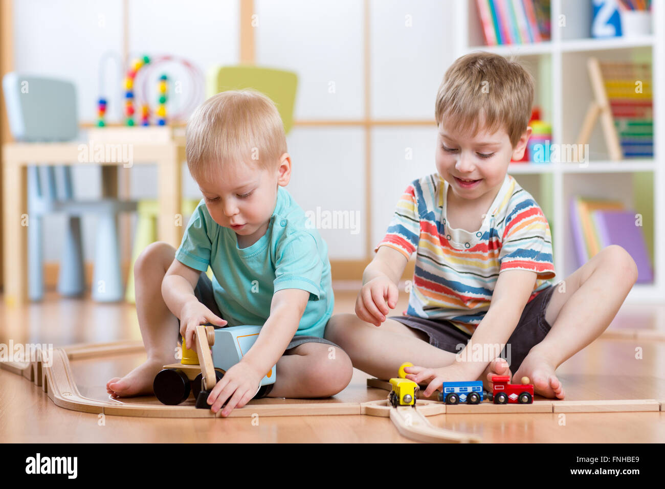 Two children little boys playing role game in daycare Stock Photo