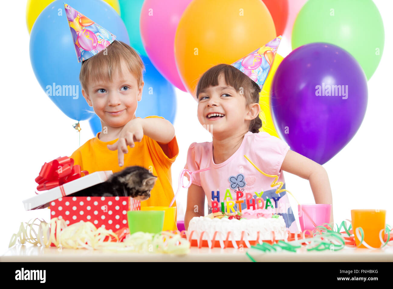 happy children celebrating birthday party with opening gift box Stock