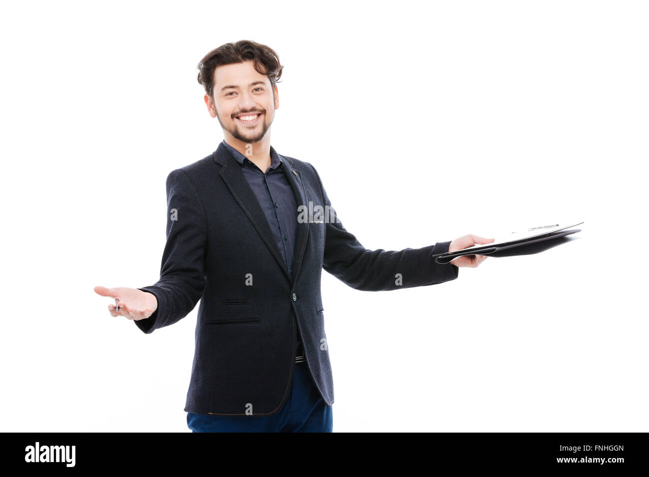 Cheerful businessman holding clipboard standing isolated on a white background Stock Photo