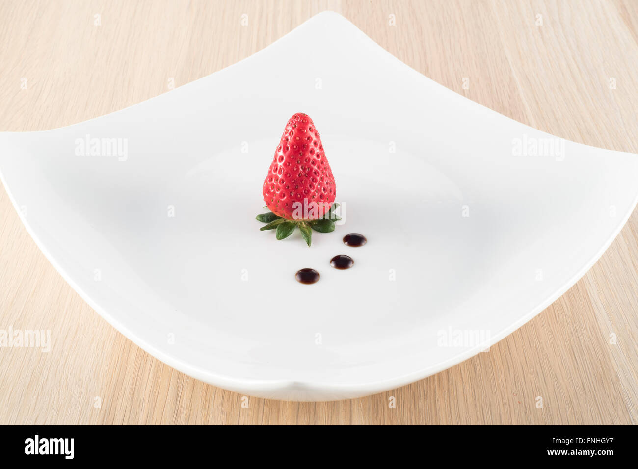 Strawberry with balsamic vinegar on white plate Stock Photo