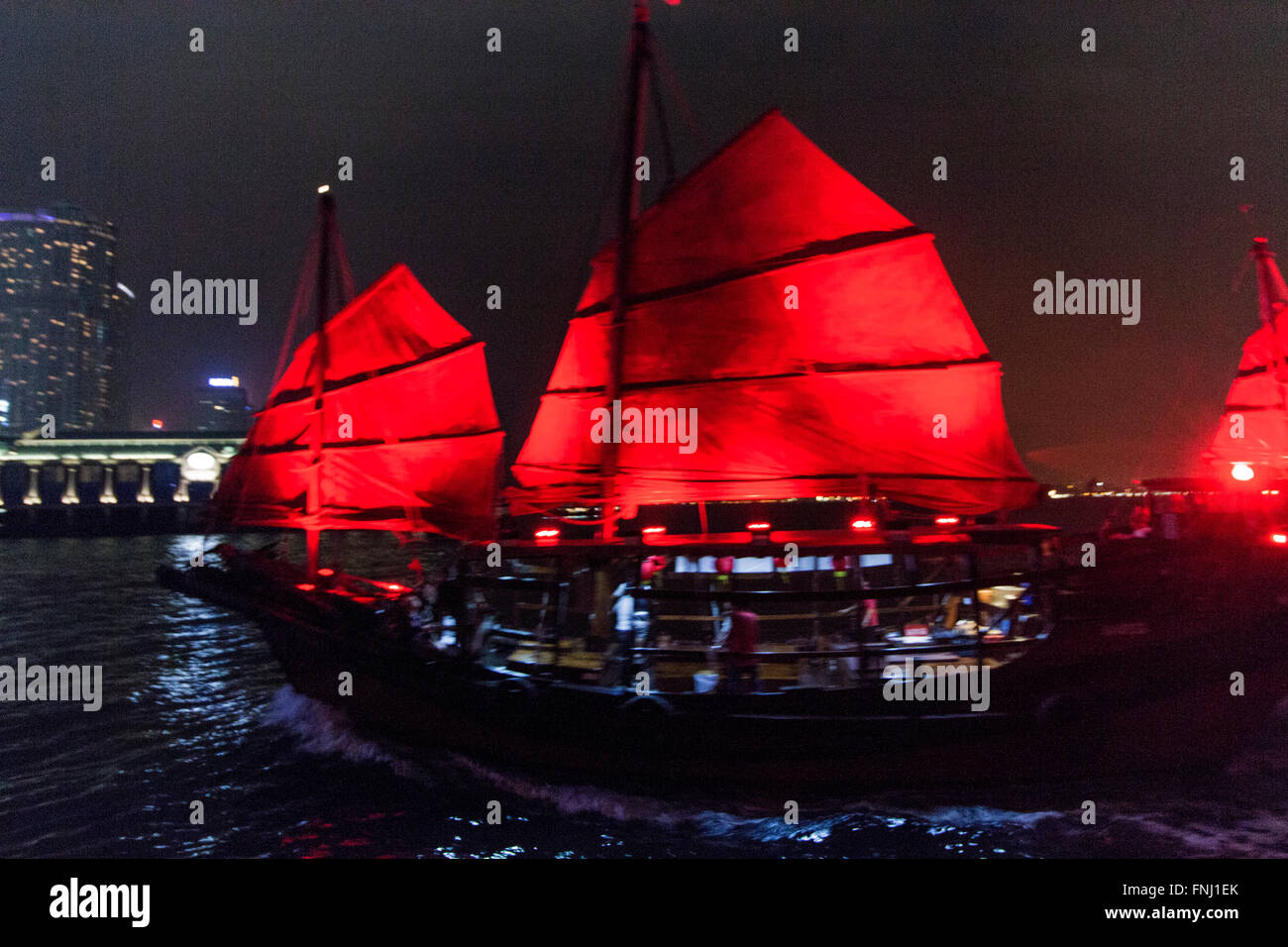 Aqua Luna Chinese pirate sailing boat in Hong Kong Victoria Harbour by night Stock Photo