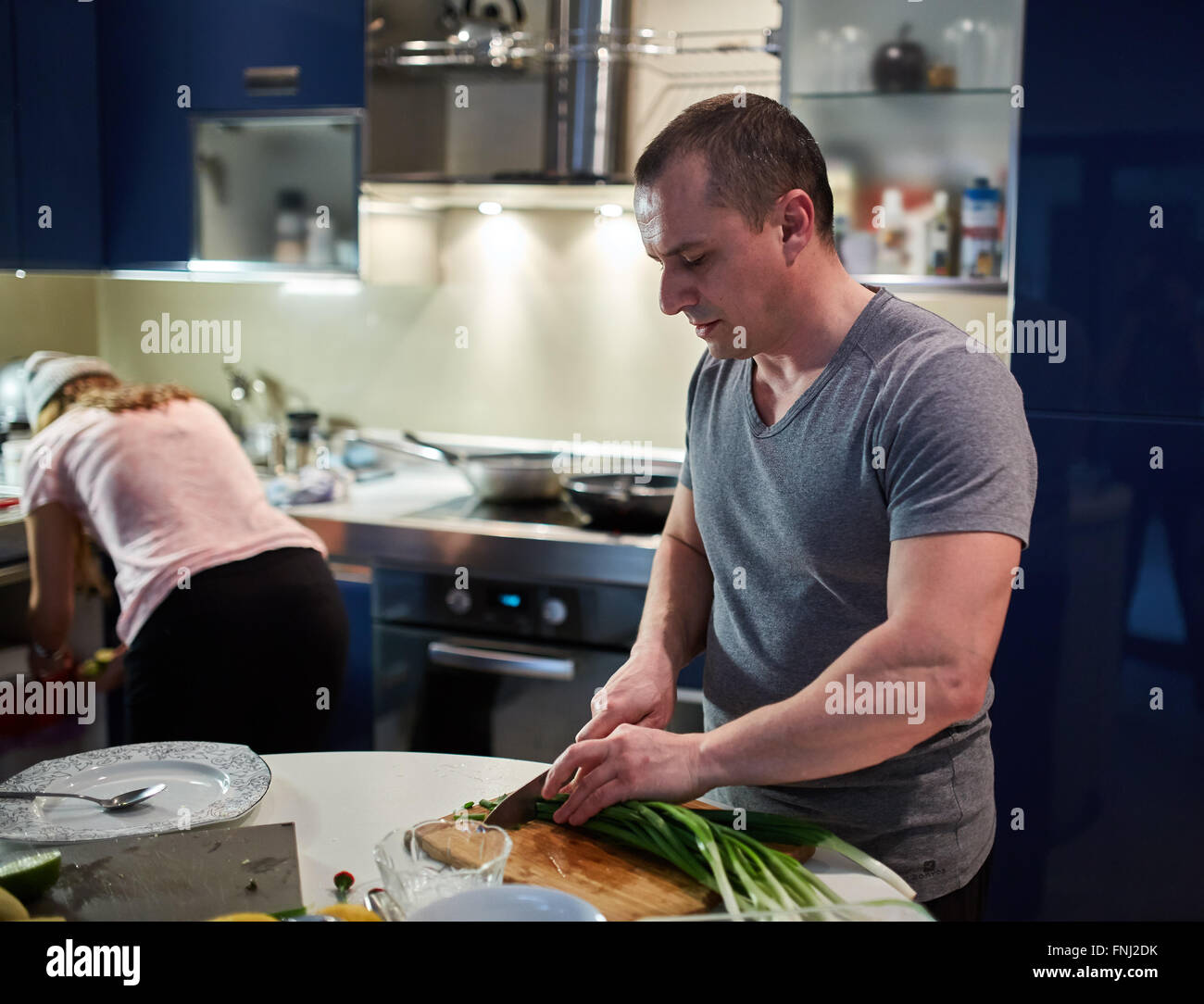 Couple cooking at home in a modern kitchen Stock Photo - Alamy