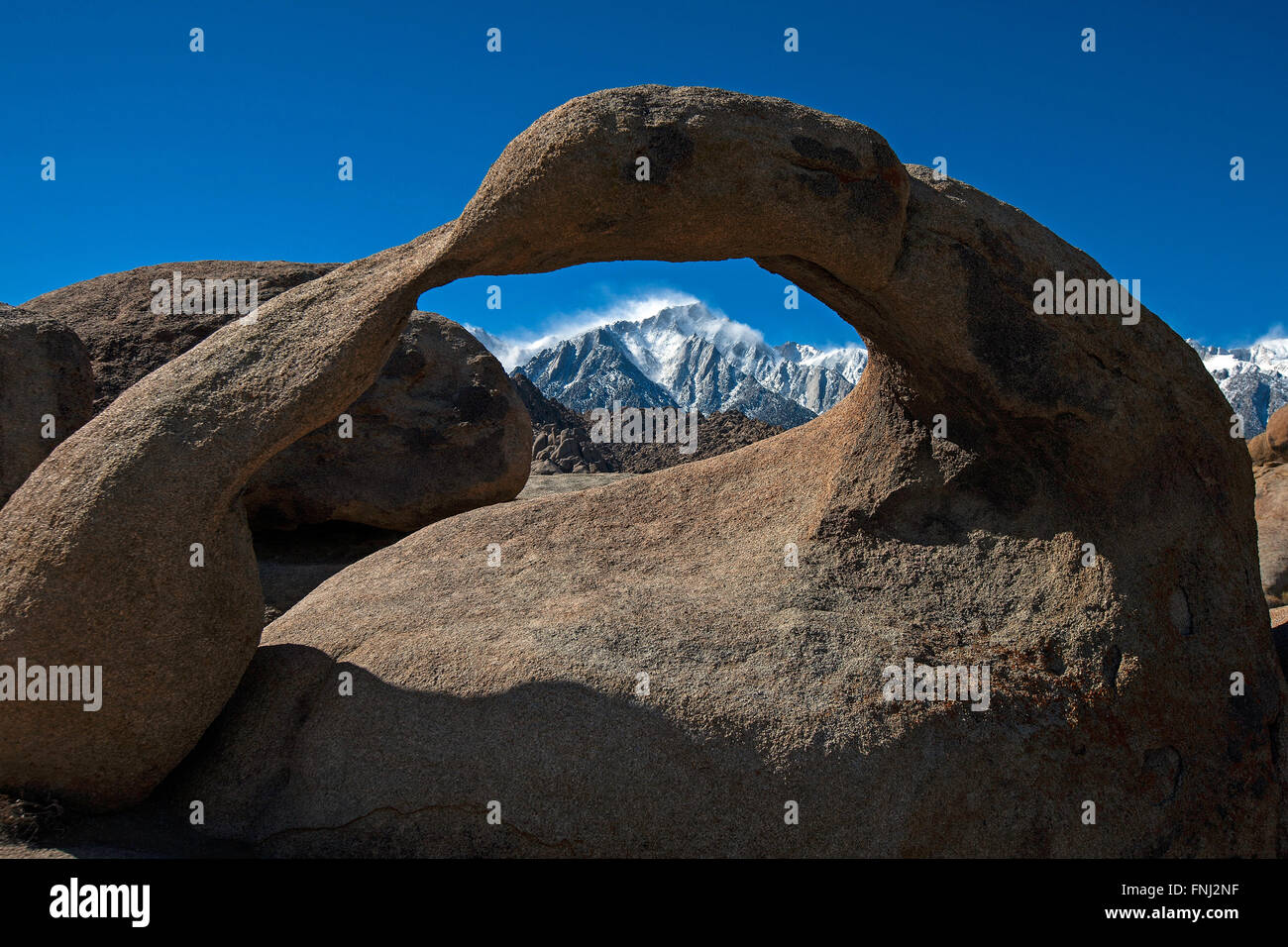 Snowcapped Mount Whitney viewed through Mobius Arch, Alabama Hills, California, United States of America Stock Photo