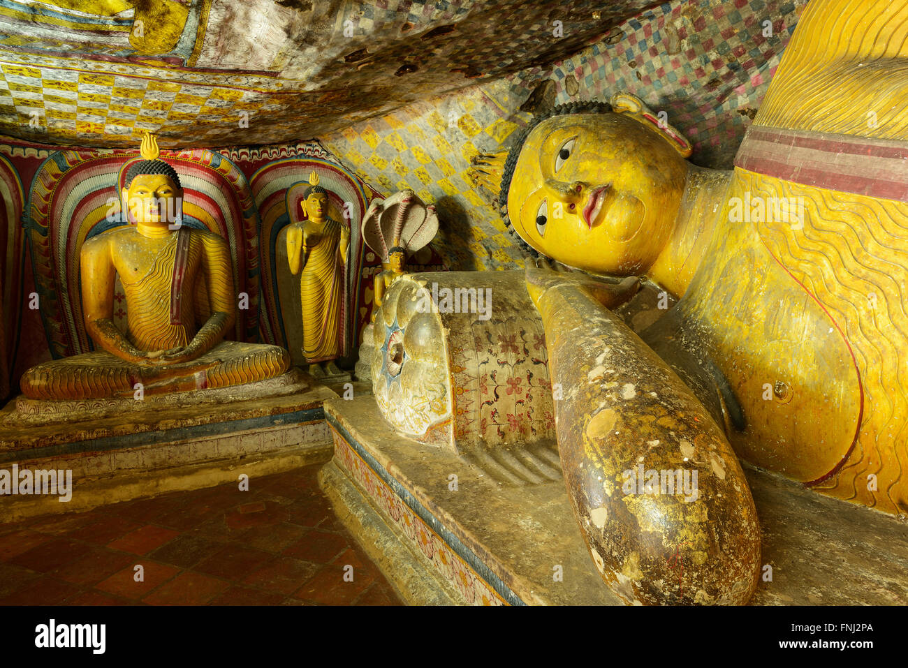 Insides of caves in ancient Buddhist complex in Dambulla cave temple. Sri Lanka.The photograph is presenting the statue of lying Stock Photo