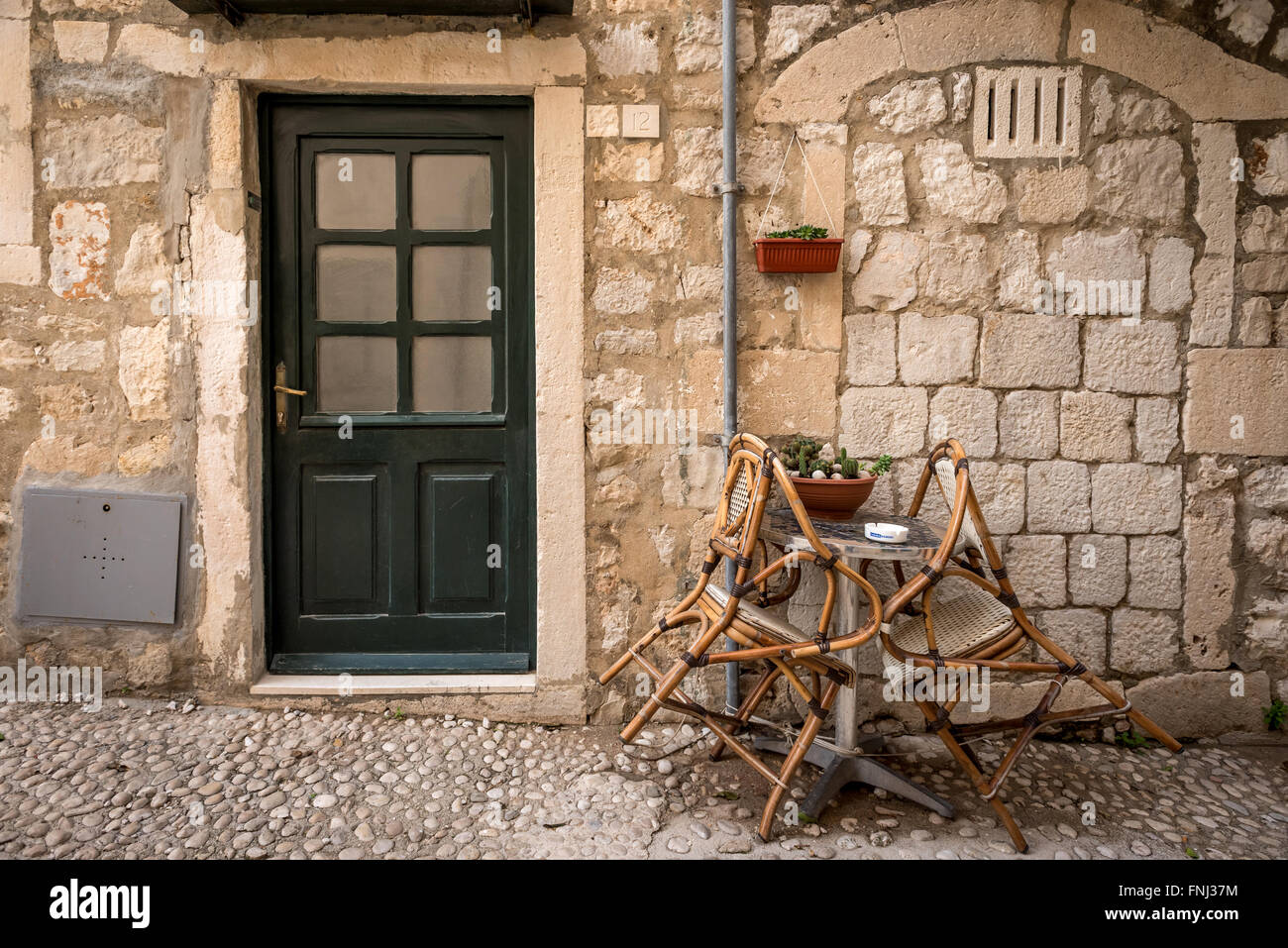 Street scene of table, chairs and a door in the old city of Dubrovnik, Croatia. Stock Photo