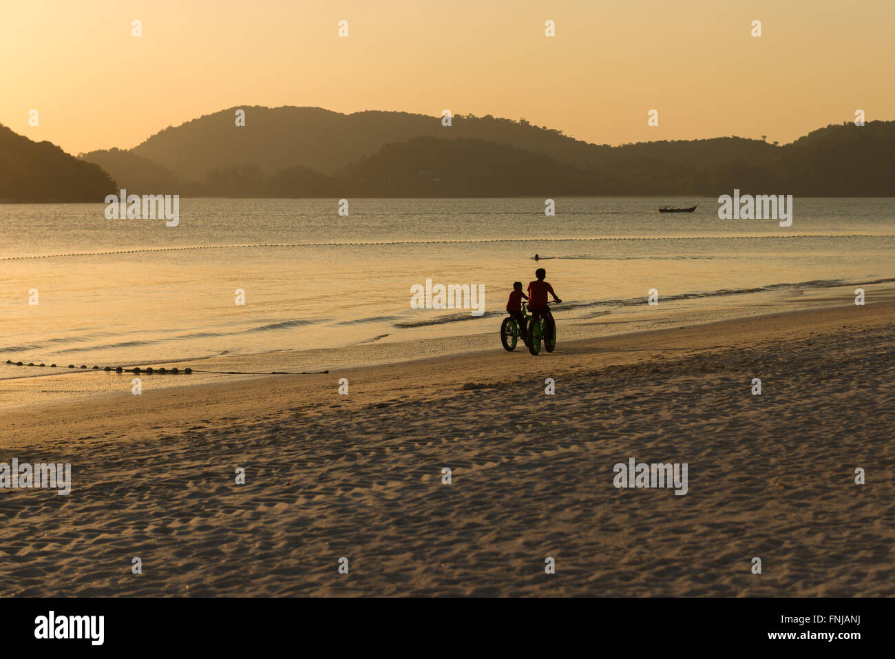 Cyclist Sihouette On Langkawi Cenang Beach, Malaysia Stock Photo