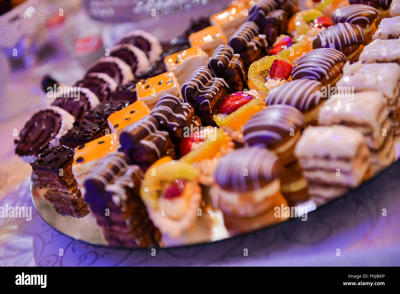 Different type of cakes on a plate and with side light Stock Photo