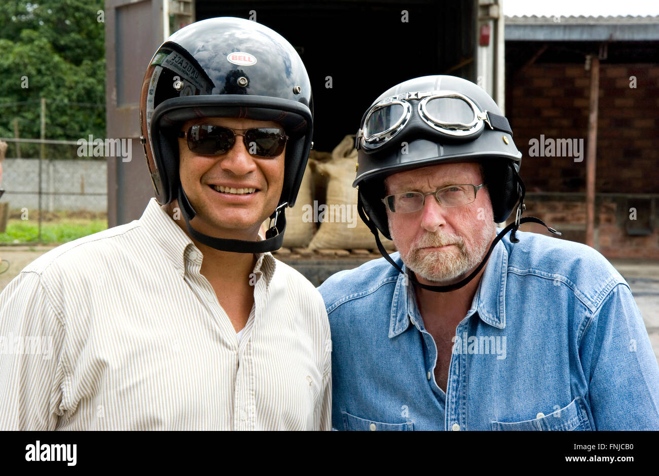 President Rafael Correa and show host Peter Greenberg put on helmets before getting on a classic motorcycle car they use to tour the Cacao region  during shooting of Ecuador: The Royal Tour. Ecuador: The Royal Tour is the seventh in a series of television specials with heads of state of different countries produced and hosted by Emmy Award-winning journalist and CBS News Travel Editor Peter Greenberg. In this latest edition, the President of Ecuador Rafael Correa offers Peter a personal guided tour of his country. The program is scheduled to premier in the U.S. on April 14th, 2016, and Stock Photo