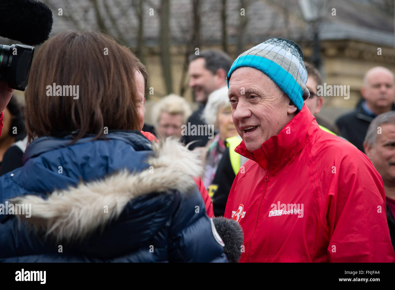Saltaire, UK. 15th March, 2016. Look North television presenter Harry Gration interviewed in Saltaire on day six of a charity three legged walk around Yorkshire for Sport Relief. Credit:  Ian Lamond/Alamy Live News Stock Photo