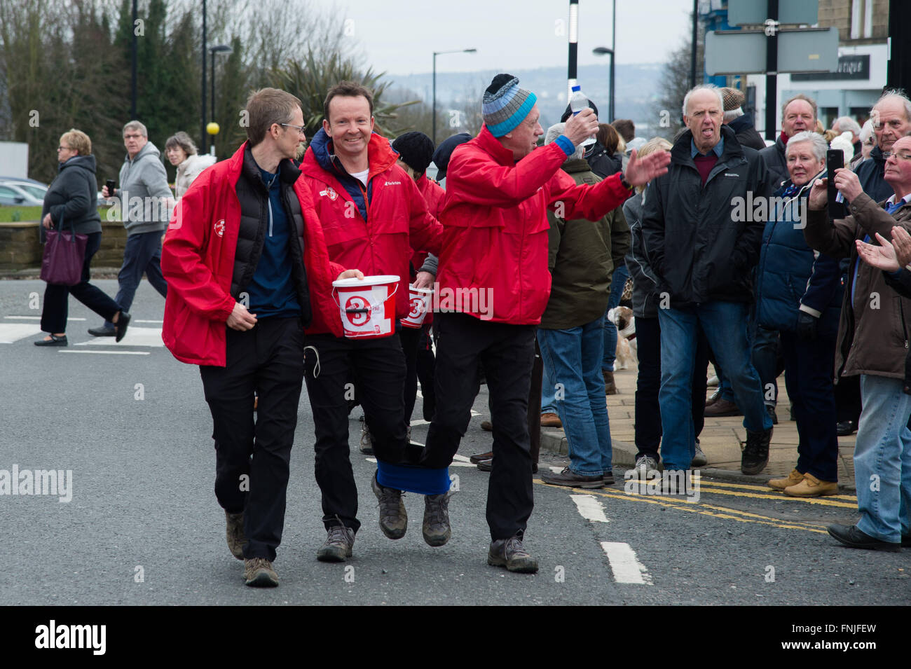 Baildon, West Yorkshire, UK. 15th March, 2016. Look North television presenter Harry Gration (right) and Look North weather man Paul Hudson (left) in Baildon village on day six of their charity three legged walk around Yorkshire for Sport Relief. Credit:  Ian Lamond/Alamy Live News Stock Photo
