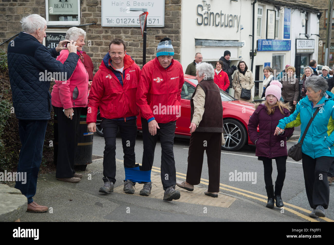 Baildon, West Yorkshire, UK. 15th March, 2016. Look North television presenter Harry Gration (right) and Look North weather man Paul Hudson (left) in Baildon village on day six of their charity three-legged walk around Yorkshire for Sport Relief. Credit:  Ian Lamond/Alamy Live News Stock Photo