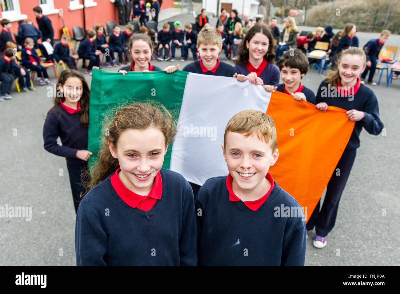 Durrus, Ireland. 15th March, 2016. Pupils Aisling Stock and  James Mallon stand in front of the Irish Tricolour before they read their version of the Proclamation at Carrigboy National School, Durrus, on Proclamation Day which was held to commemorate the events of 1916. Credit: Andy Gibson/Alamy Live News. Stock Photo
