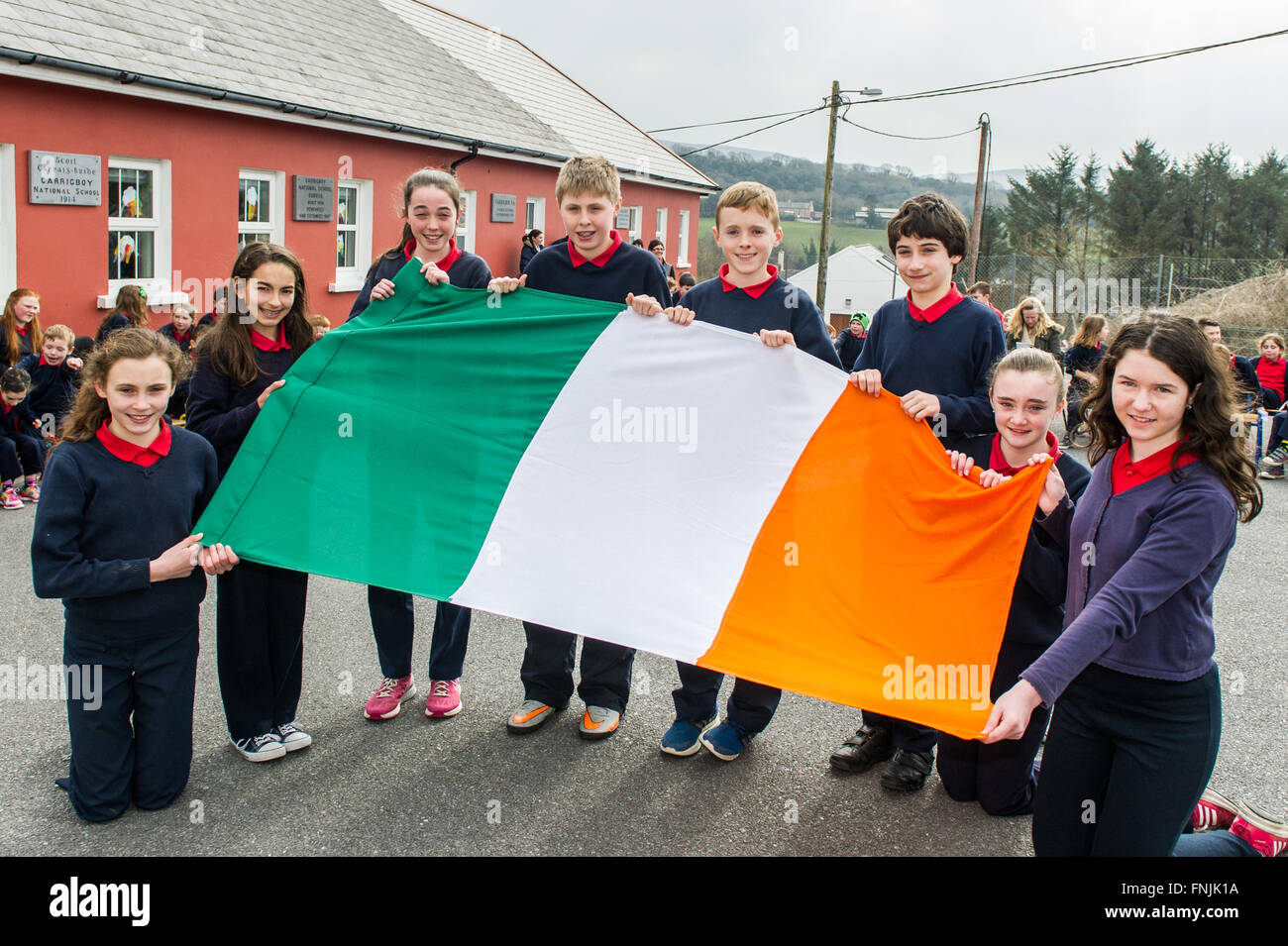 Durrus, Ireland. 15th March, 2016. Pupils Aisling Stock; Niamh Bignall; Rebecca Harrington; Luke Daly; James Mallon; Eoin Stock; Erica Ross and Jessica O'Driscoll display the Irish Tricolour before the raising of the flag at Carrigboy National School, Durrus, on Proclamation Day which was held to commemorate the events of 1916. Credit: Andy Gibson/Alamy Live News. Stock Photo