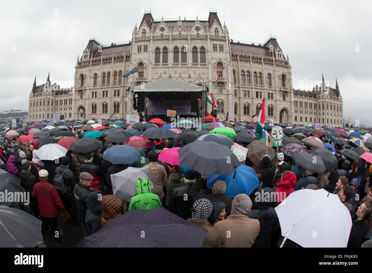 Budapest, Hungary. 15th Mar, 2016. People participate in a protest in Budapest, Hungary, March 15, 2016. Tens of thousands of people braved steady rain and near freezing weather to march through Budapest on Tuesday, and gathered in front of parliament to demand sweeping changes in the education system, underlining demands with a call for a general strike. © Attila Volgyi/Xinhua/Alamy Live News Stock Photo