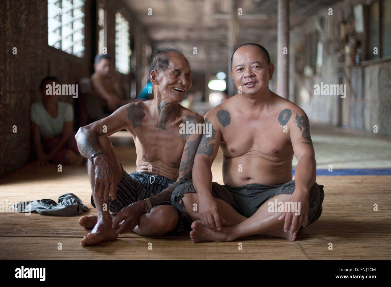 Two Iban men are sitting inside a traditional Iban longhouse near Lubok Antu, Malaysia, on 23.10.2014. Photo: Sebastian Kahnert - NO WIRE SERVICE - Stock Photo