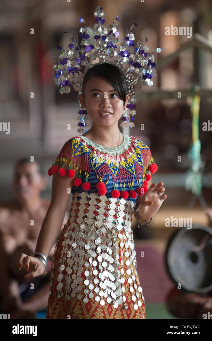 An Iban woman is performing a dance inside a traditional Iban longhouse near Lubok Antu, Malaysia, on 23.10.2014. Photo: Sebastian Kahnert Stock Photo
