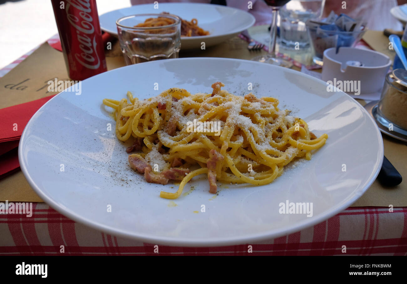 A classic pasta Carbonara served outside in a pizzeria restaurant in Lucca, Italy, on June 06, 2015 Stock Photo