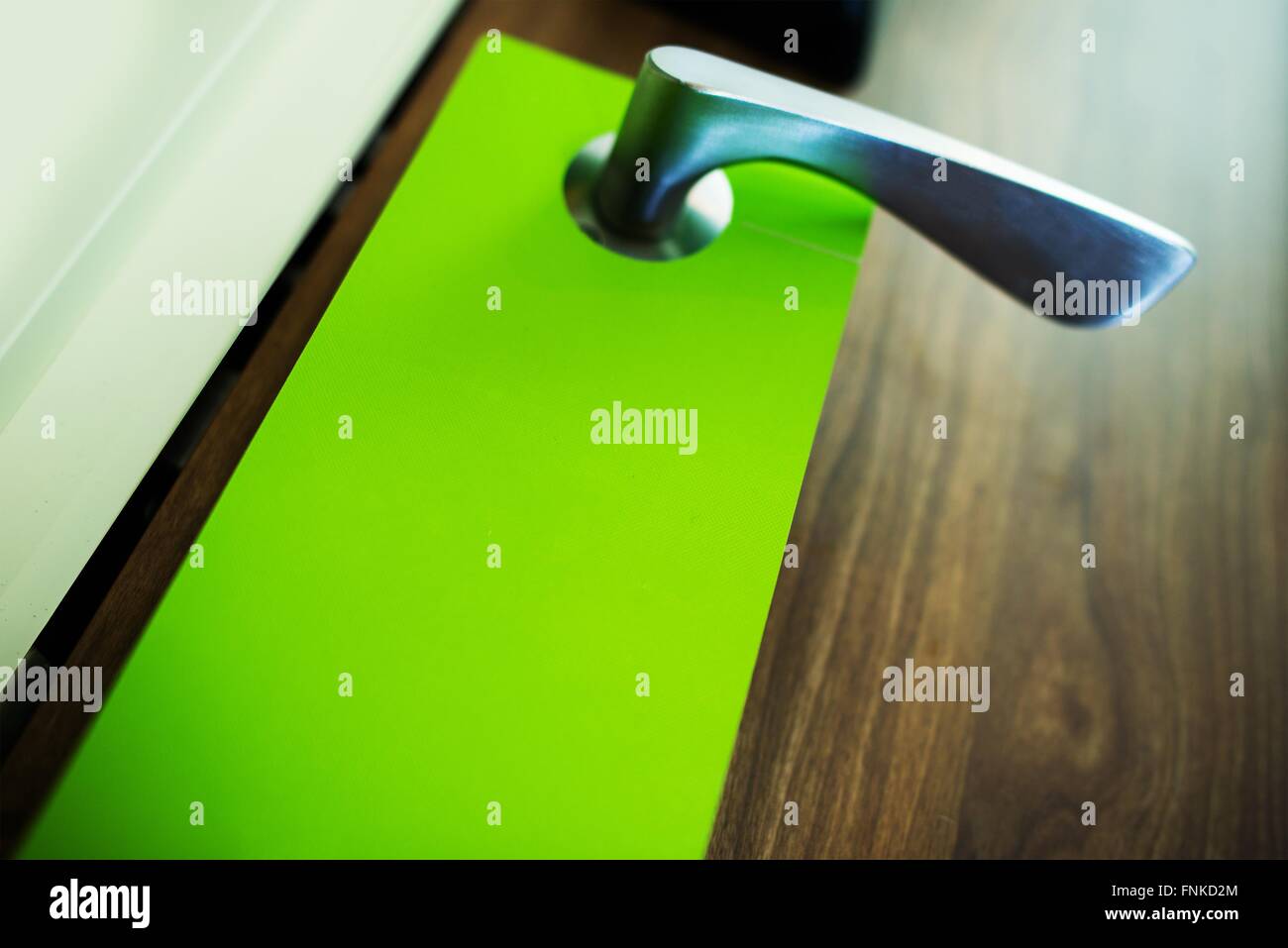 Green Door Hanger Flyer Closeup Photo. Door Hanger Marketing. Stock Photo