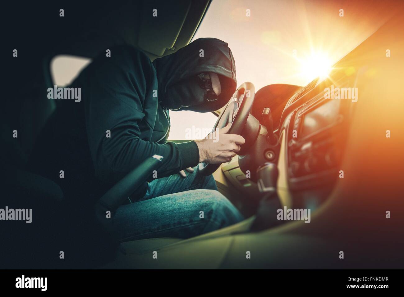 Car Thief in a Black Mask and Black Glasses. Car Thief Inside the