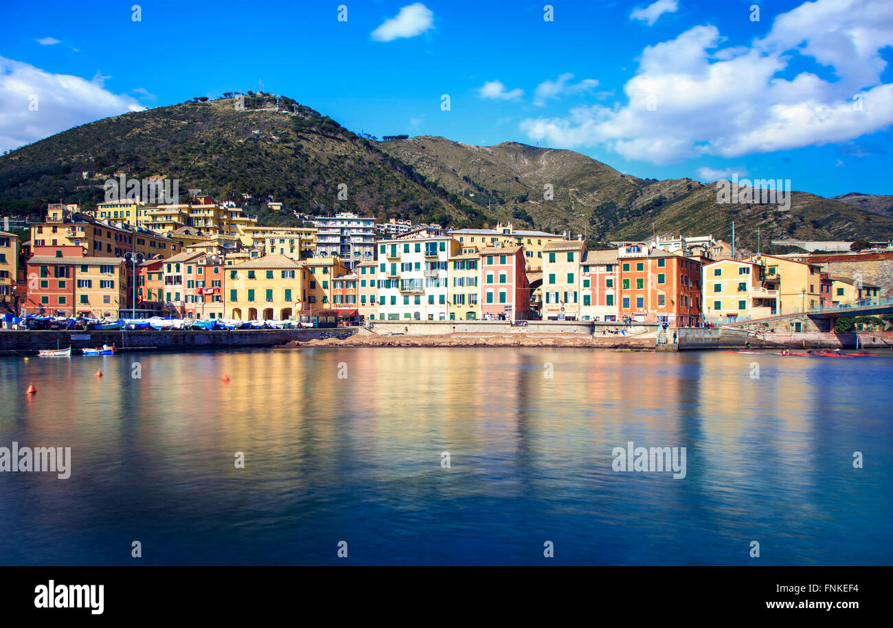 Houses and resort hotels at the ocean shoreline with mountains in the background at Nervi, Italy Stock Photo