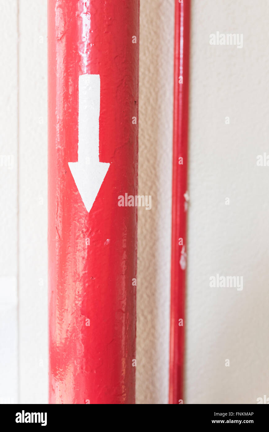 Red pipe have arrow on it and pointing direction Stock Photo