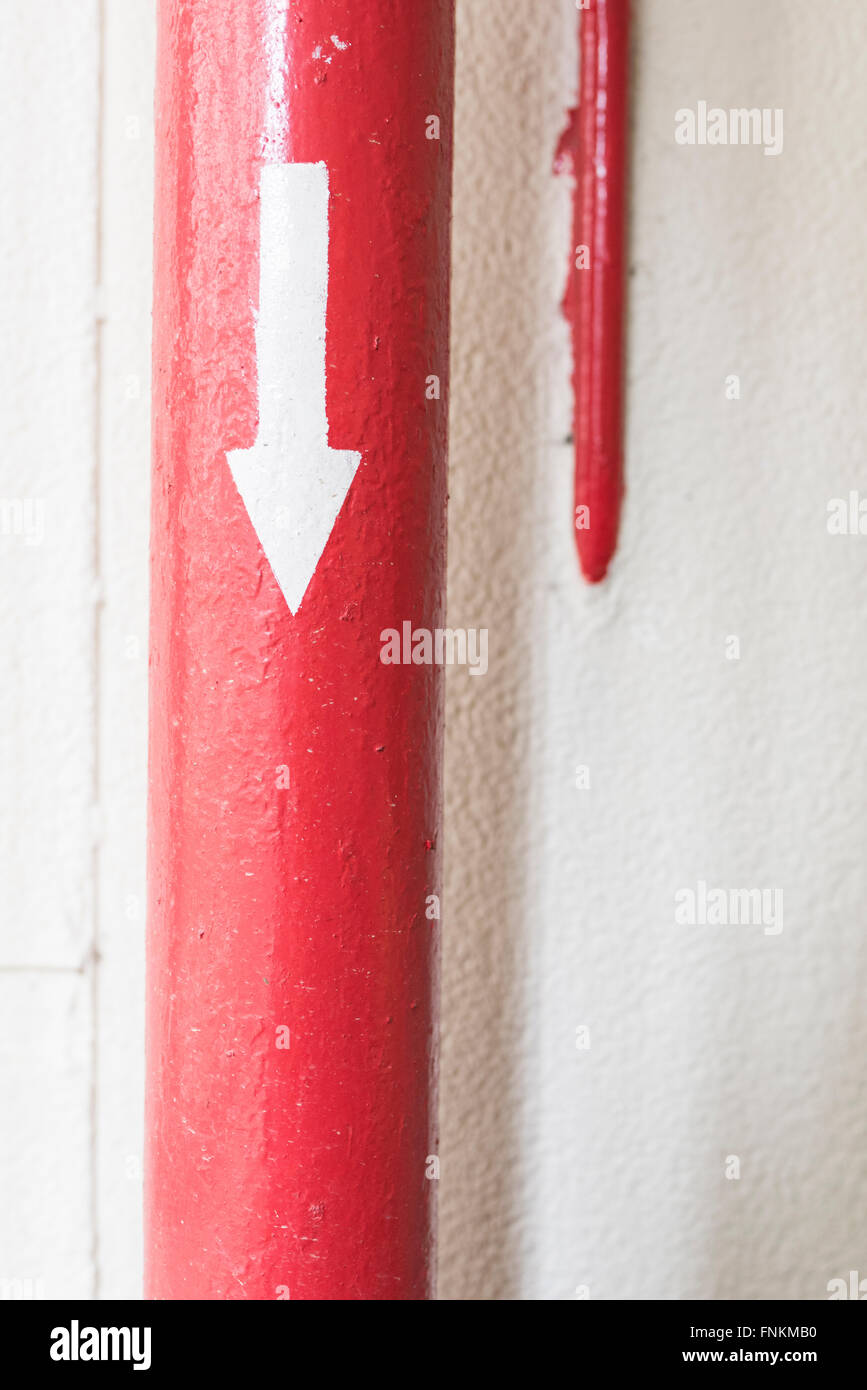 Red pipe have arrow on it and pointing direction Stock Photo