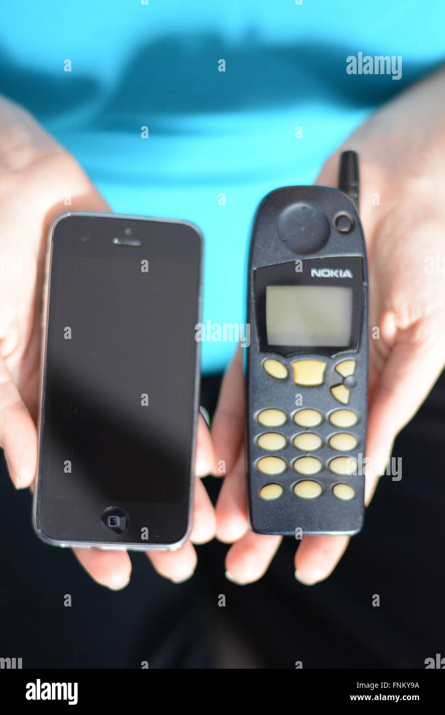 Evolution of technology with old Nokia phone and a modern smartphone Stock Photo