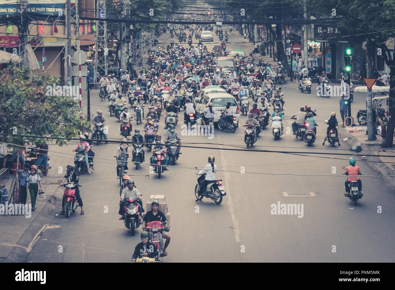 many scooter drivers , motorbike traffic , streets of saigon, vietnam Stock Photo