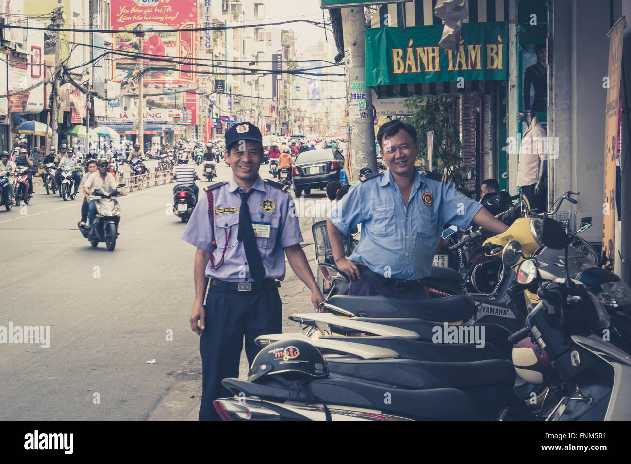portrait of two police men , street of saigon, vietnam - vintage photo Stock Photo