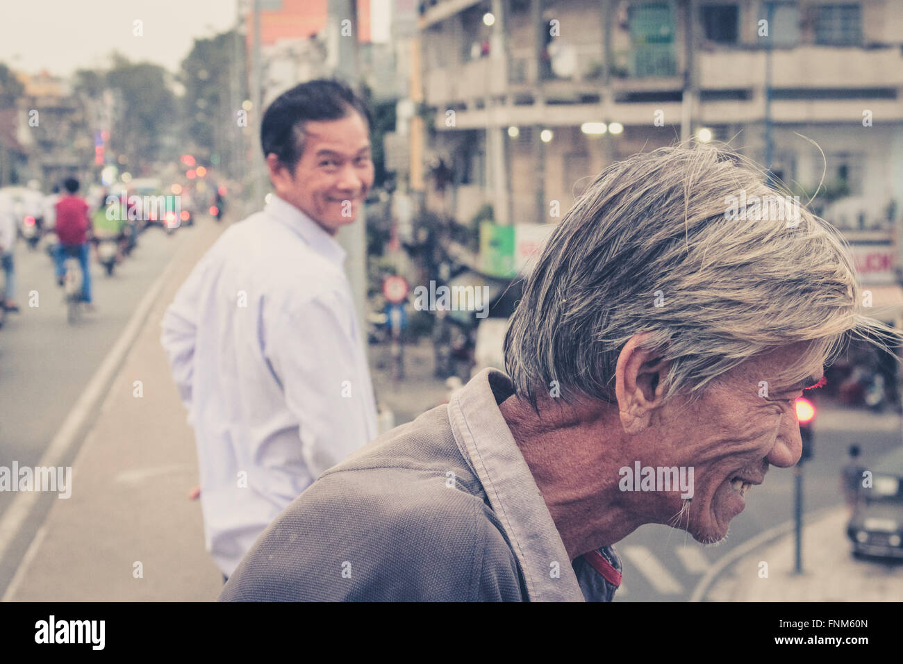 portrait of two smiling men in saigon vietnam Stock Photo